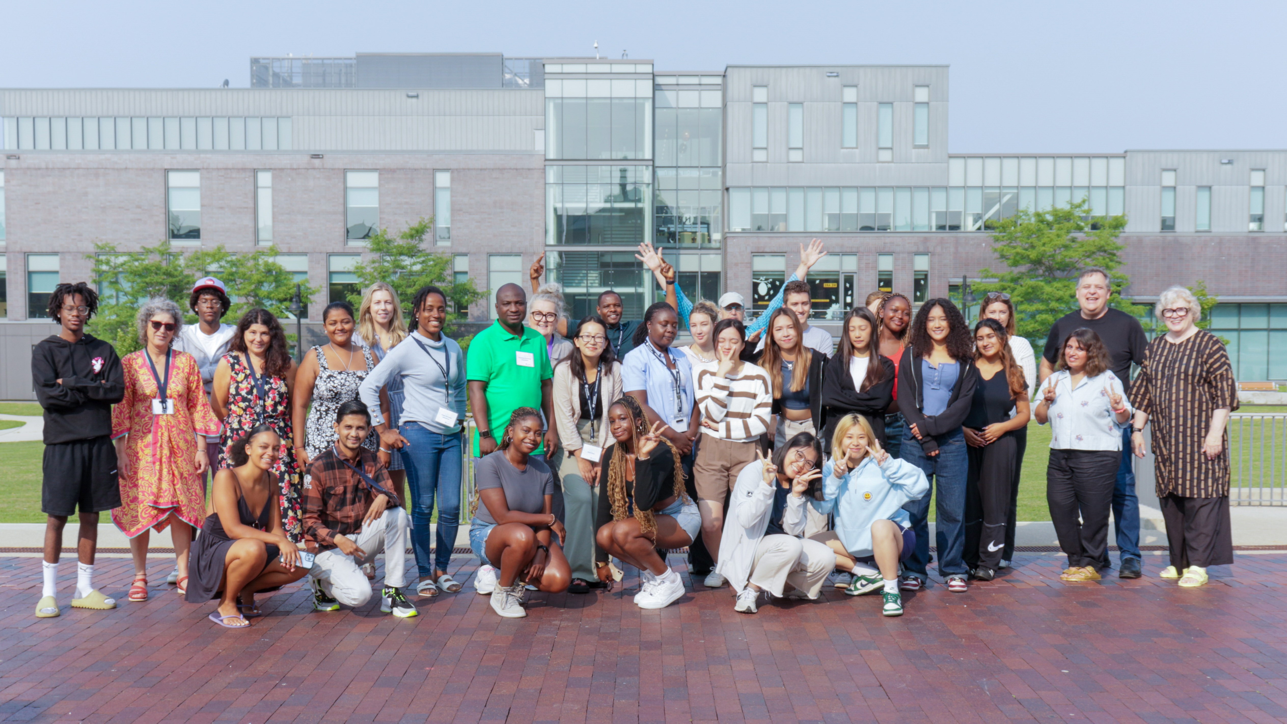 A large group of people pose in front of Humber' Lakeshore campus