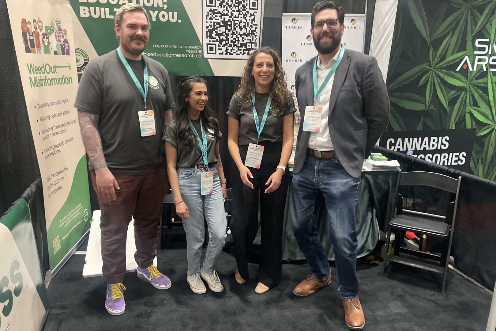 Four people stand in a trade show booth