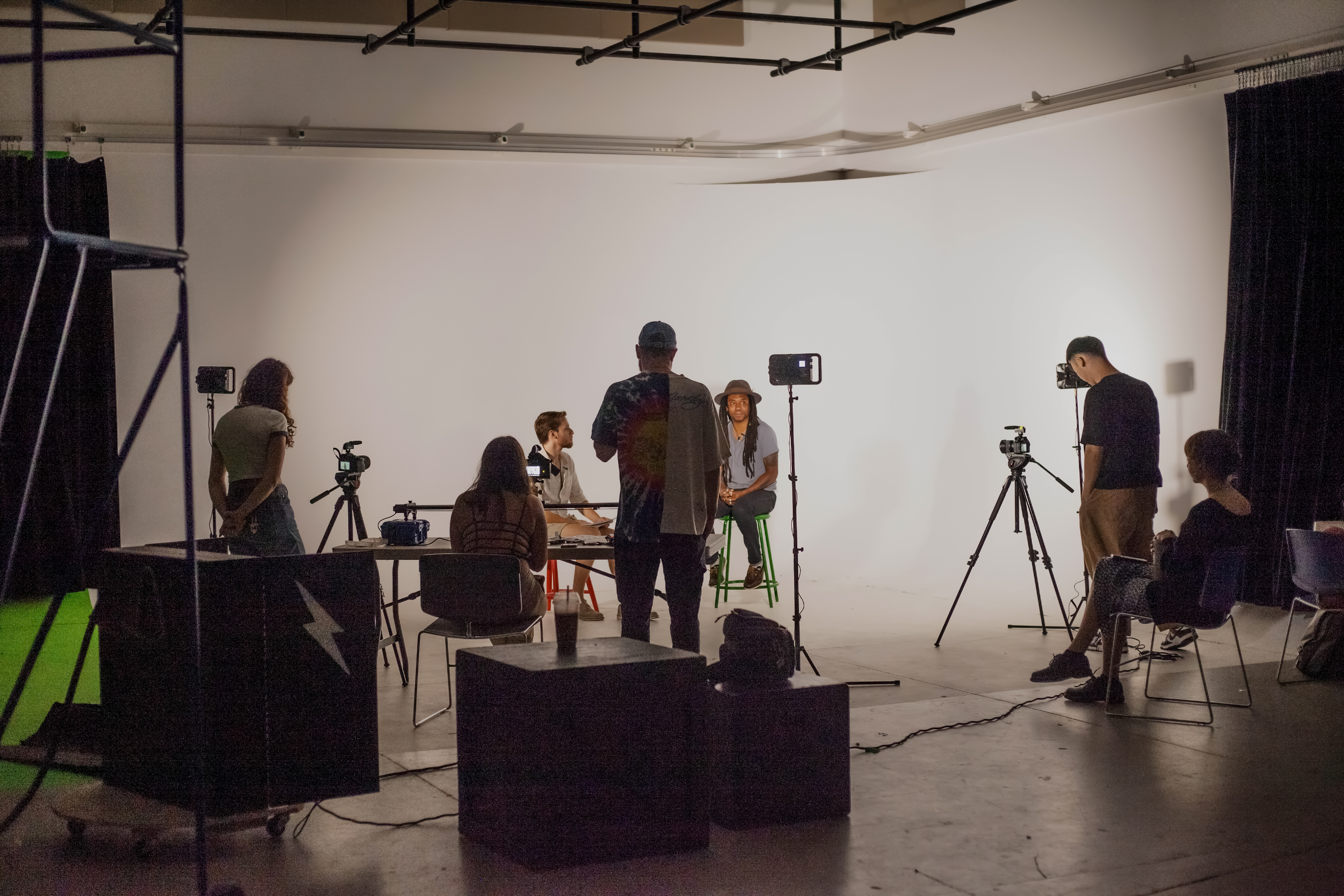 Students work on a set conducting an interview.
