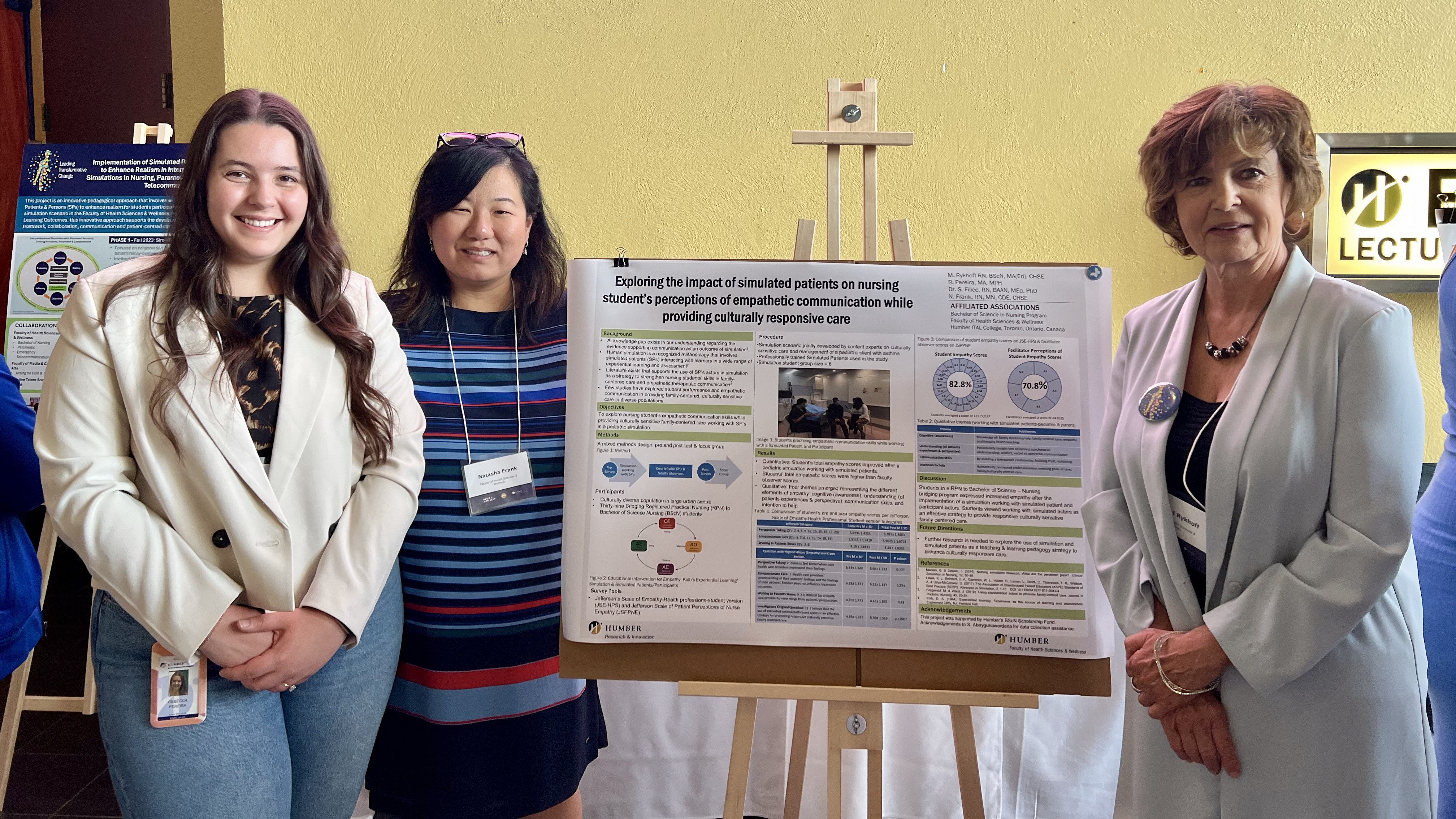 Three people pose in front of a poster presentation.