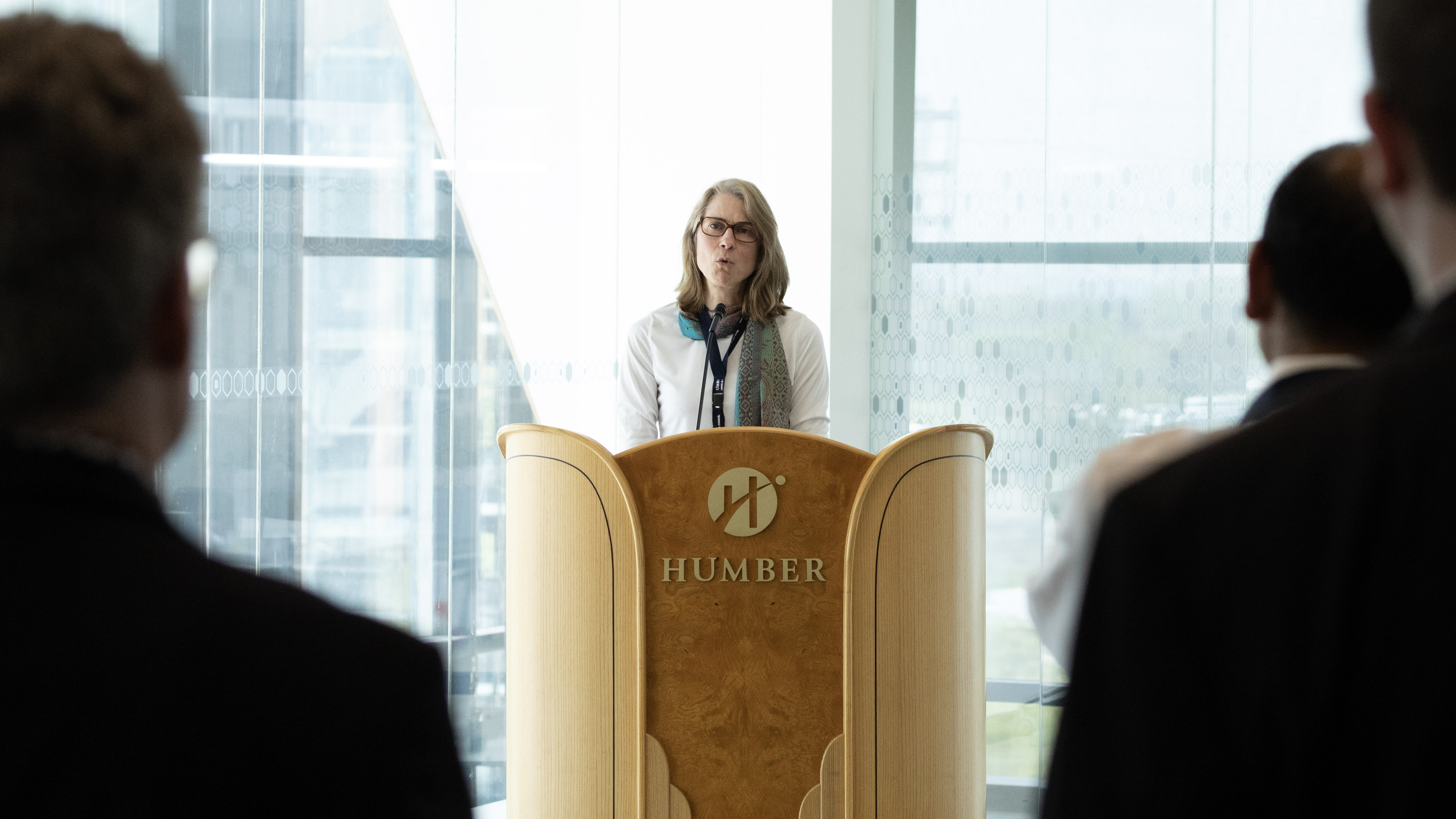 Madeleine Noland, President of the Advanced Television Systems Committee Inc. (ATSC) stands at a podium.