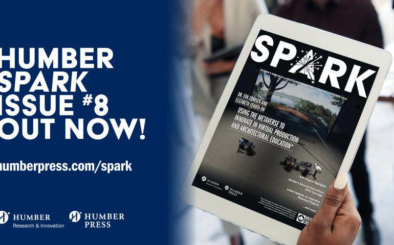 A hand holds a tablet displaying the cover of Spark Issue 8.